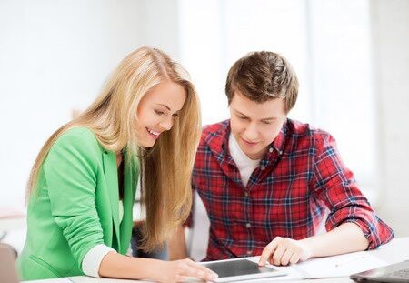 Image of Two Students Working Together on Tablet Device