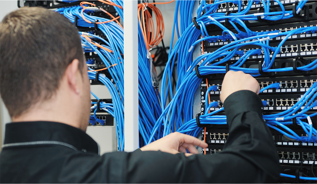 Image of Technician Patching in Cables Image of Technician Patching in Cables