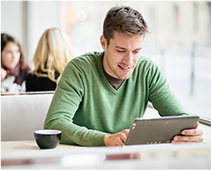 Image of Man Working on Tablet at Coffee Shop