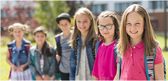 Image of Young Students Outside with Backpacks Image of Young Students Outside with Backpacks