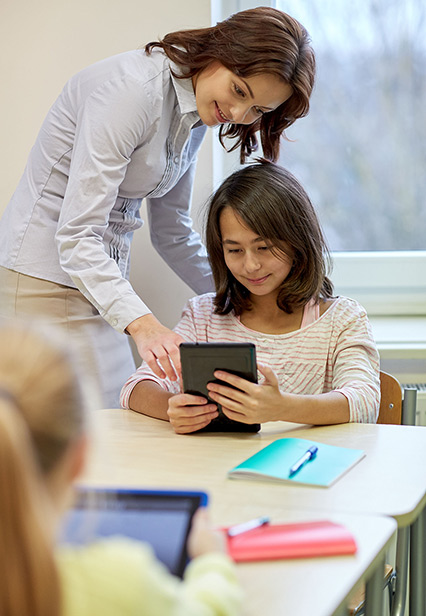 Image of Teacher Working with Student on Tablet